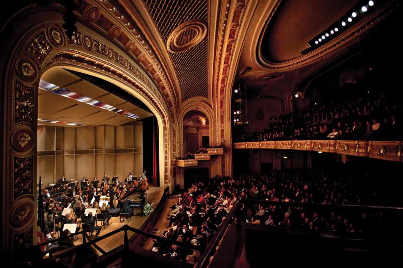 photo of symphony on stage and audience at the tivoli